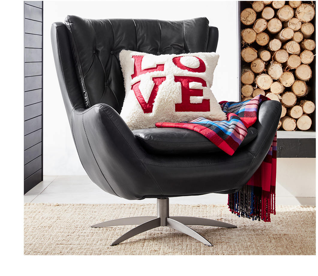 LOVE sherpa pillow on a leather swivel arm chair.