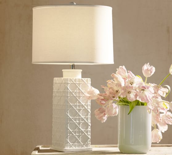 white ceramic lamp with flower on base